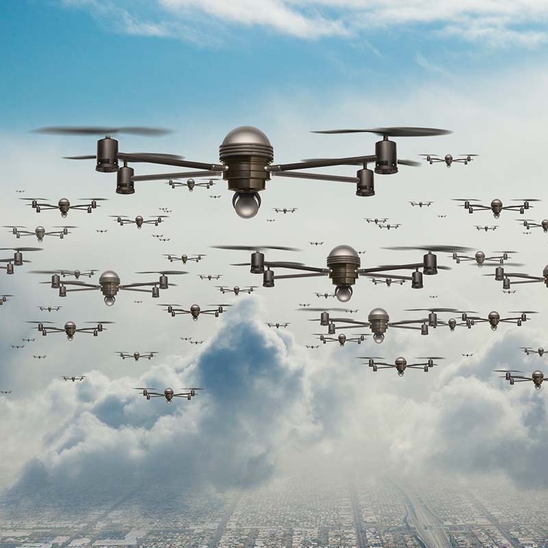Drones in flying formation above a city