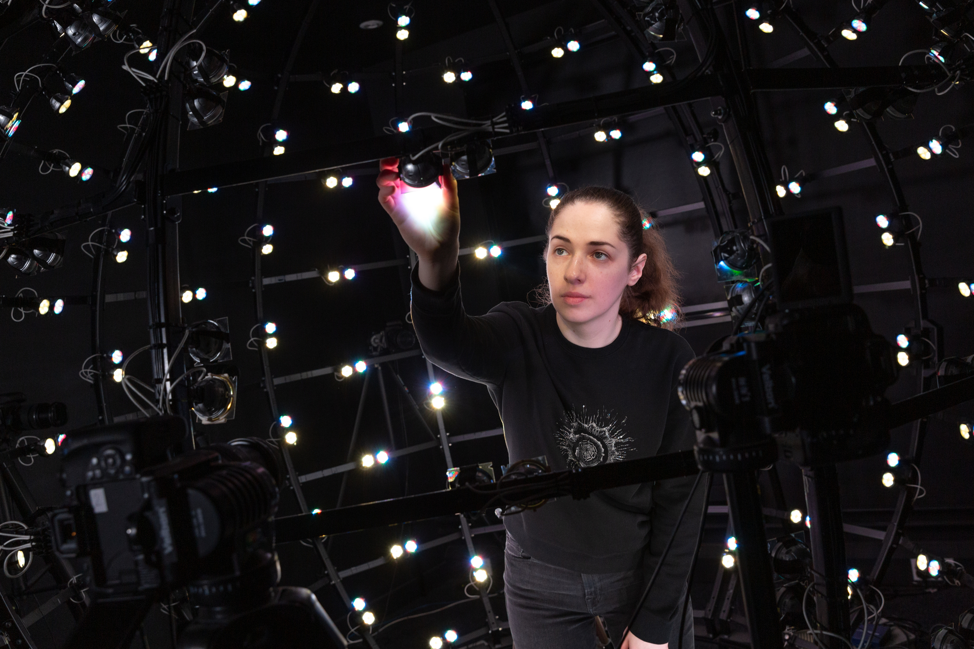 A woman scientist making adjustments to the Imperial College Multispectral Light Stage